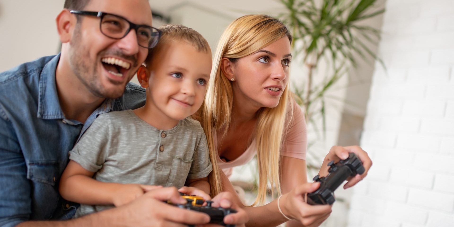 Young family playing video games at home.