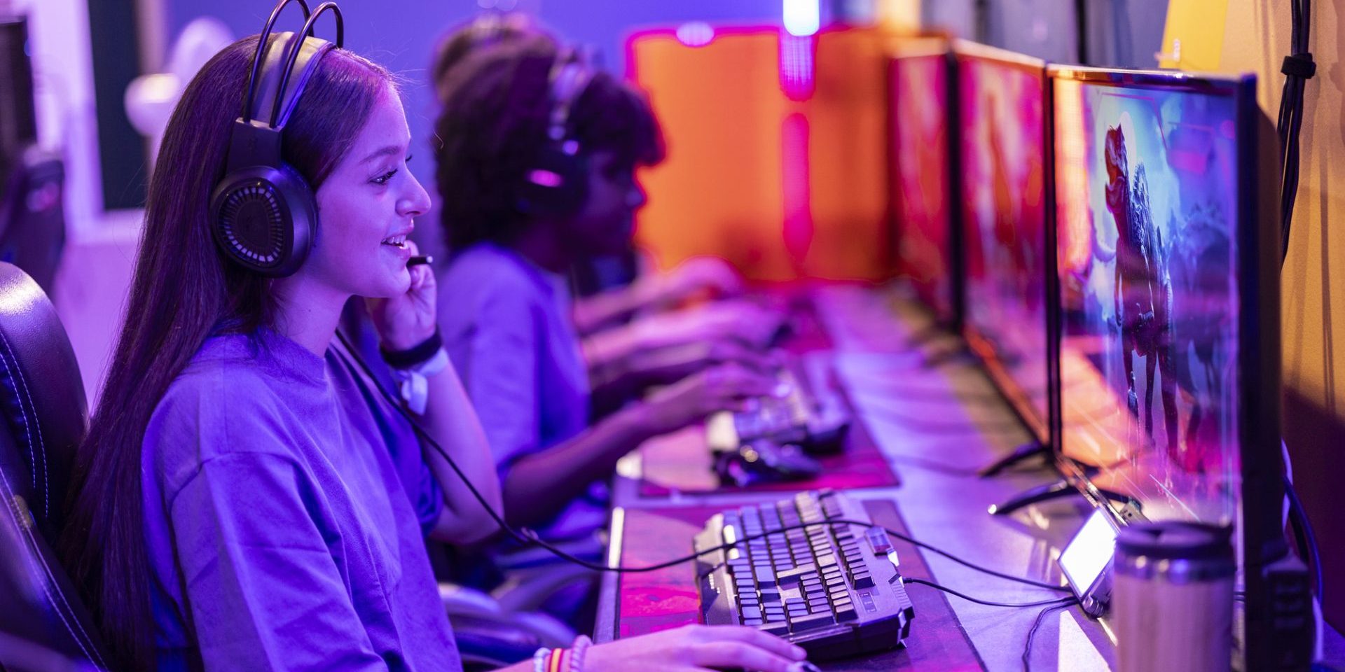 A focused young gamer interacts with her team during a collaborative eSports gaming session.